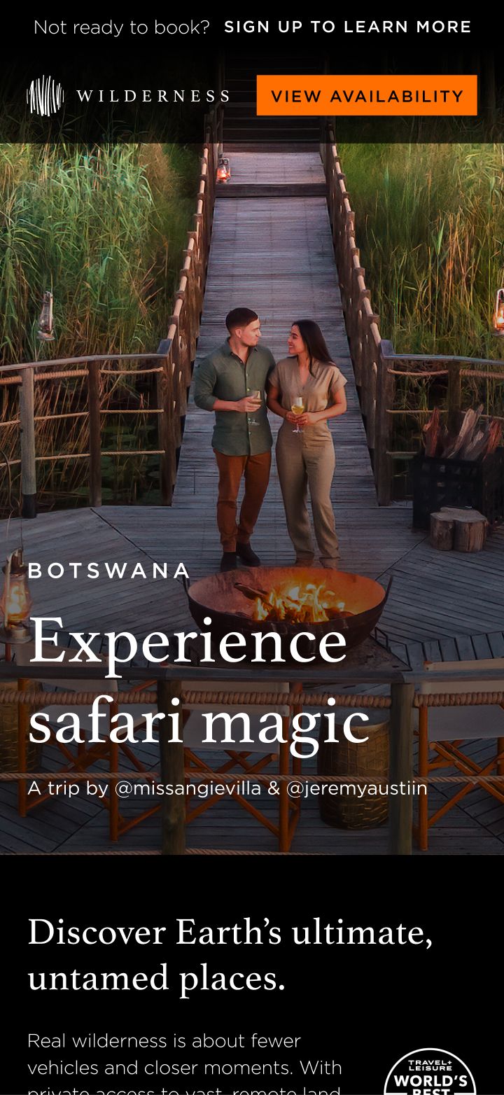 A couple stands on a wooden boardwalk surrounded by tall grasses, with a fire pit in the foreground, promoting a Botswana safari experience.